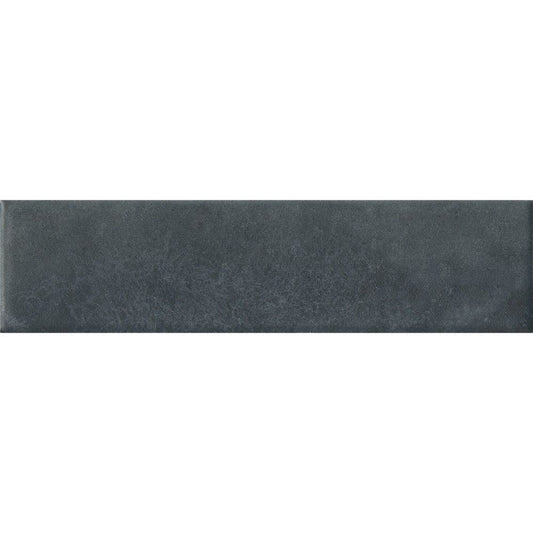 Stack of Cera 2x9 Blu Notte matte porcelain wall tiles showing the deep blue color