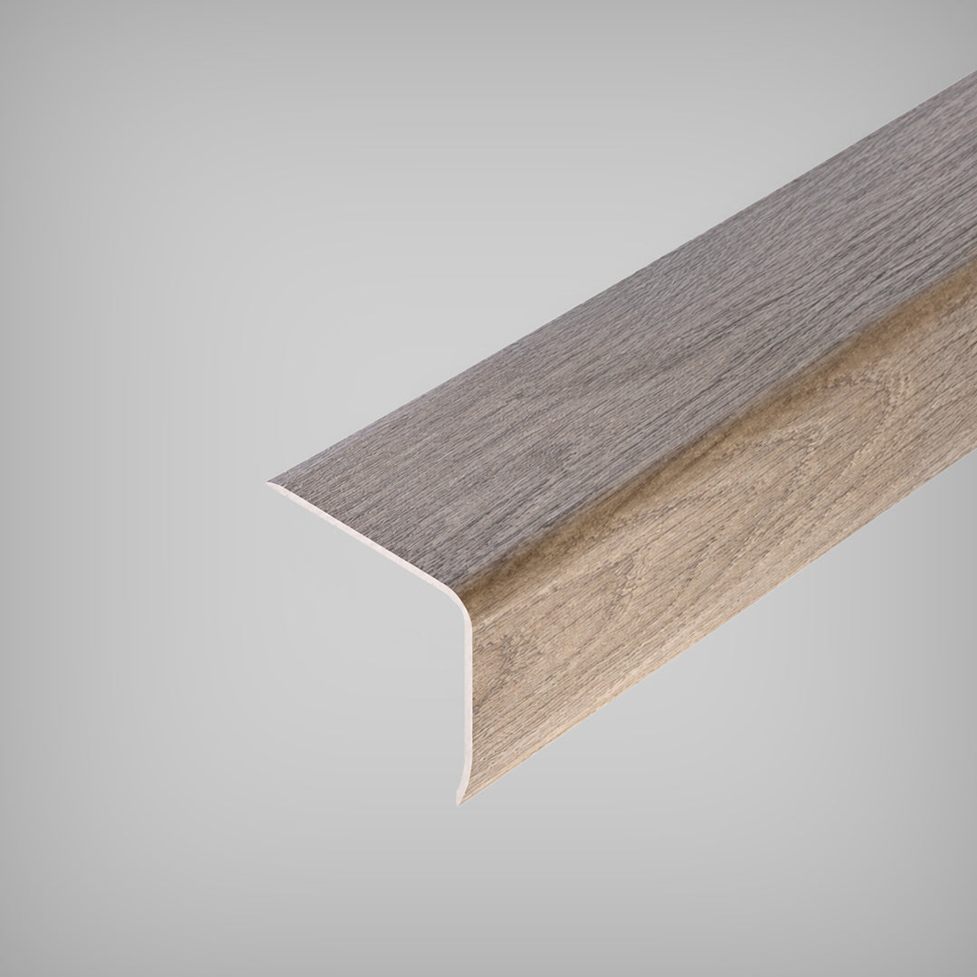 Close-up view of an Inhaus Stairnose Max molding with a wood grain texture