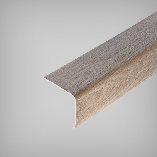 Close-up view of an Inhaus Stairnose Max molding with a wood grain texture