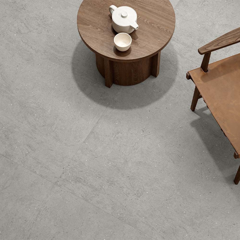 Detail shot of the texture and color variation present in the Canve Argile 24x24 glazed porcelain tile.