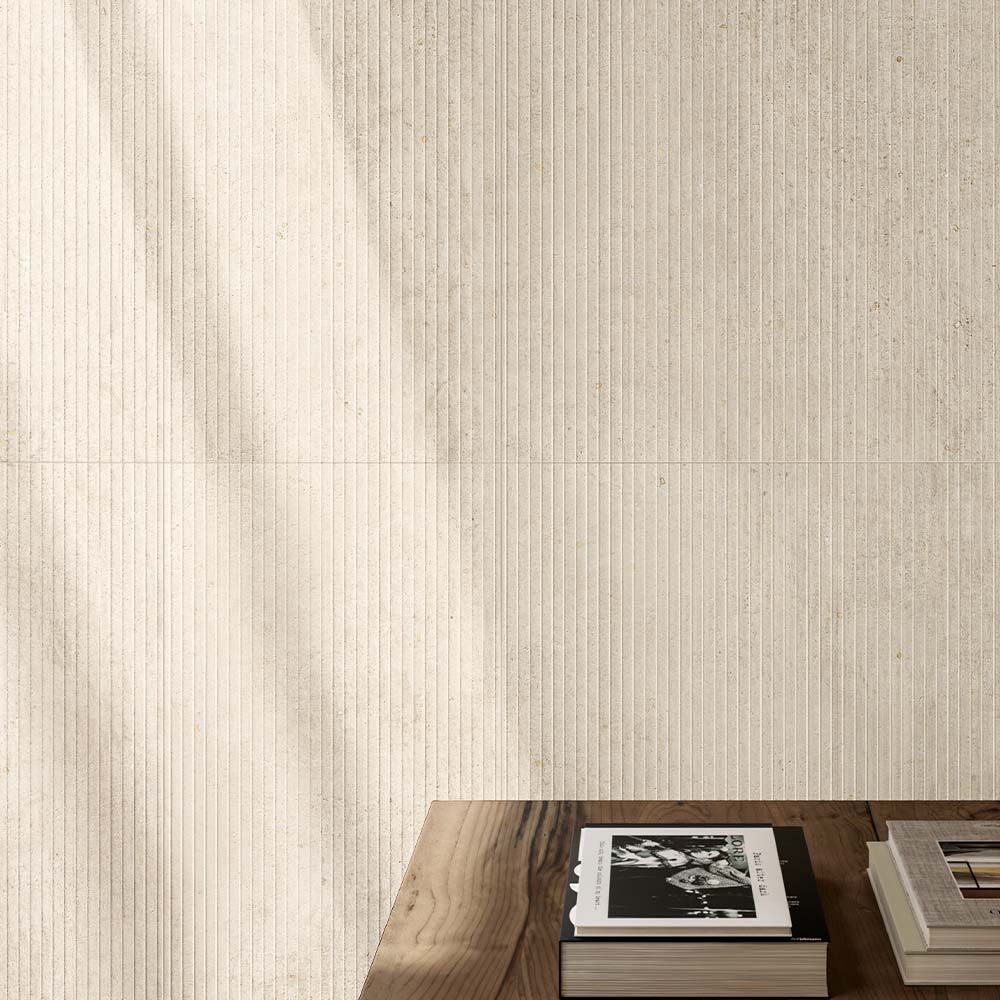 A room setting featuring the Canve Craie 3D Trait matte glazed porcelain tile installed on a wall, highlighting its large format and subtle 3D pattern.