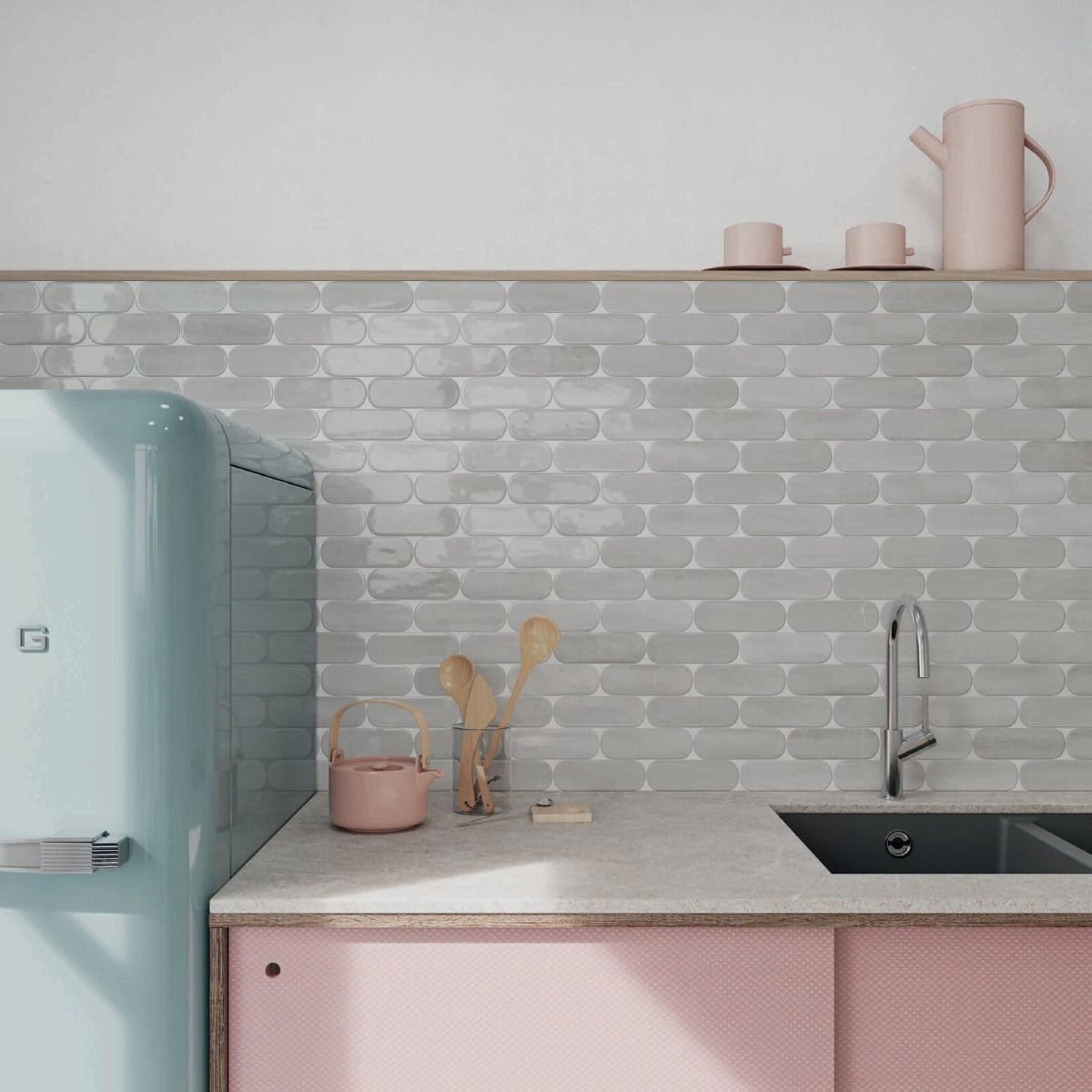 A stack of Calema 2"x6" Cloud Gloss Oval ceramic tiles, highlighting their unique oval shape and reflective surface.