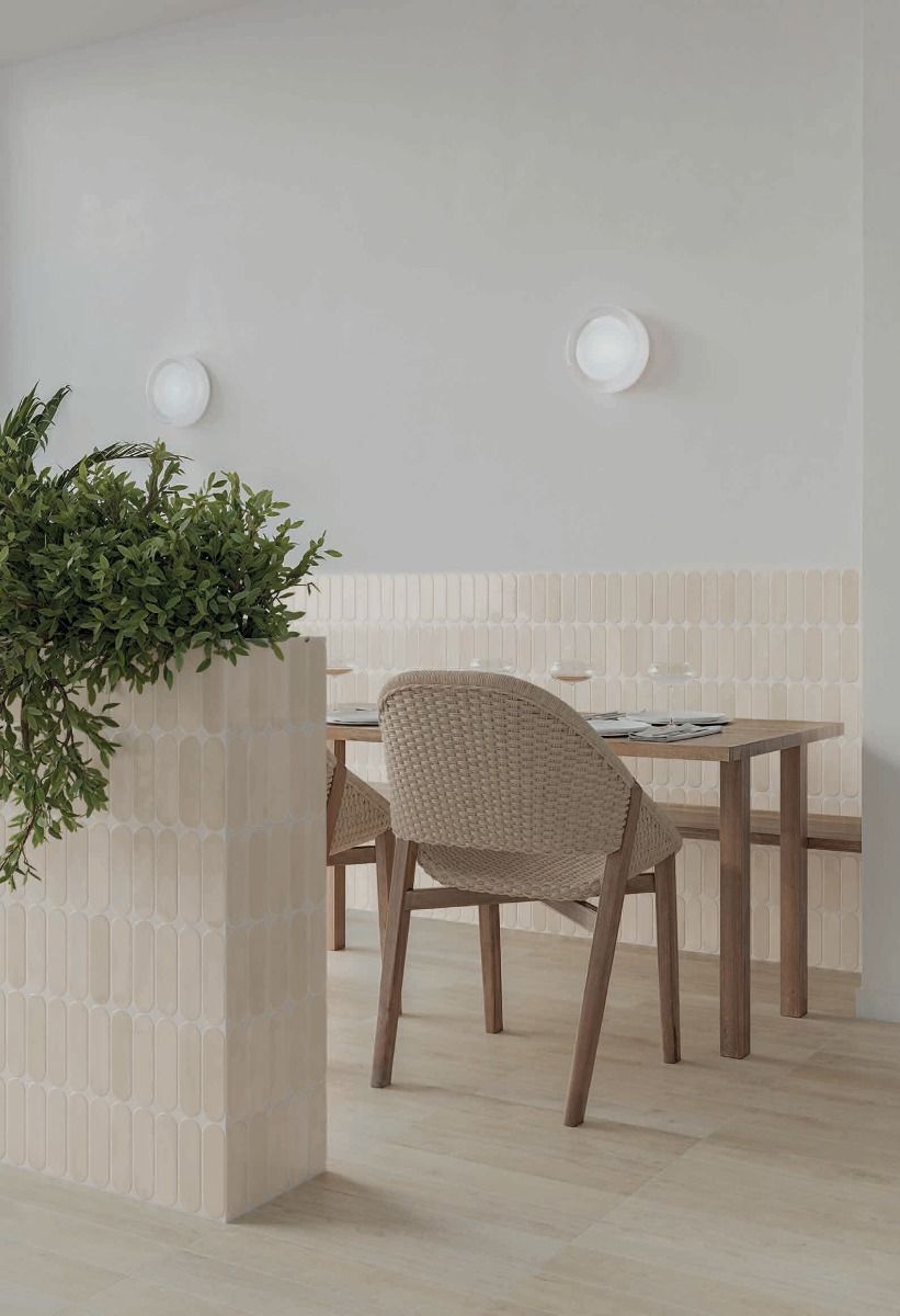 Arrangement of multiple Calema Greige Gloss Oval ceramic wall tiles, highlighting the substantial variation in shade and pattern.