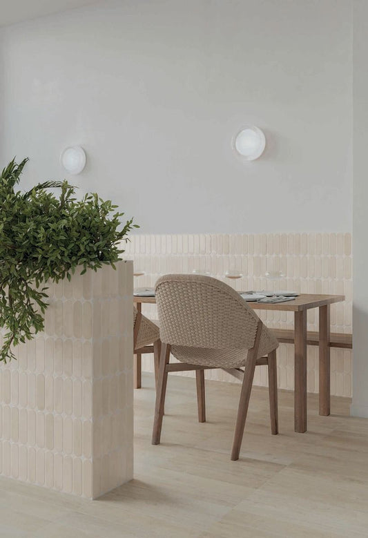 Arrangement of multiple Calema Greige Gloss Oval ceramic wall tiles, highlighting the substantial variation in shade and pattern.