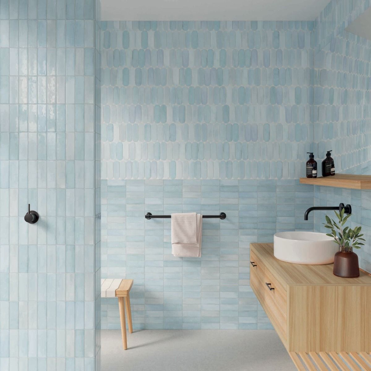 Arrangement of multiple Calema 2"x6" Sky Gloss Glazed Ceramic Wall Tiles showcasing the substantial variation in shade and texture