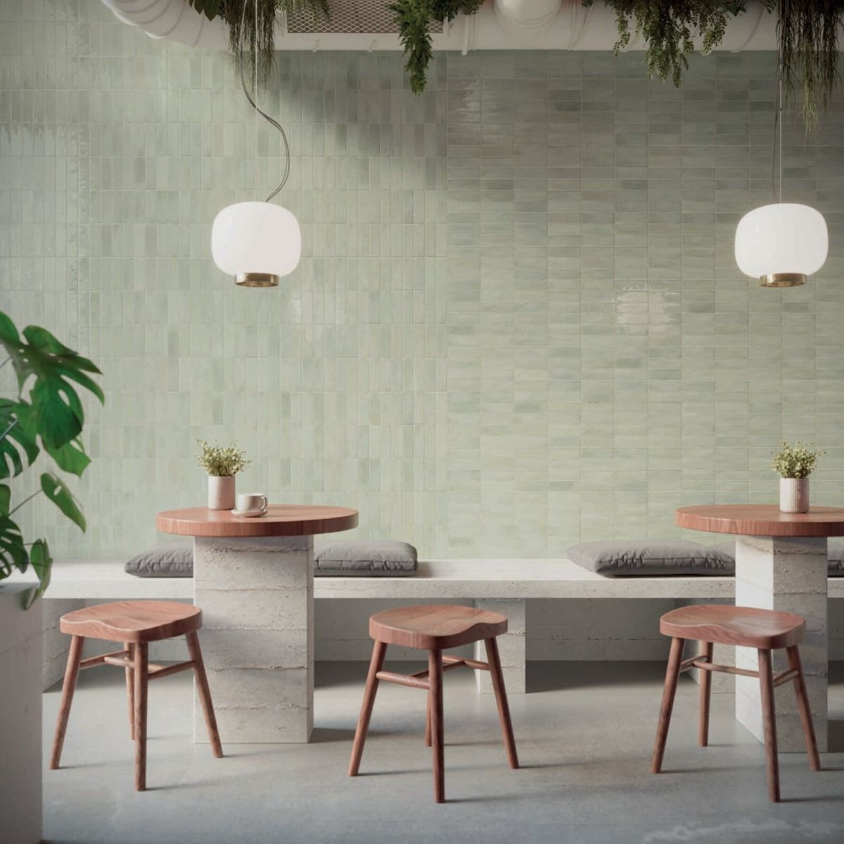 A stack of Calema Tea Gloss 2x6 ceramic tiles, with a single tile pulled forward to display its color and reflective surface.