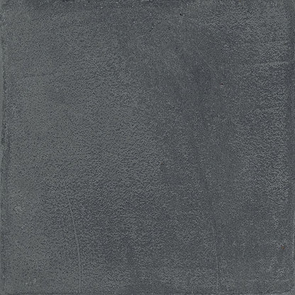 A tiled surface featuring Chalk 8x8 Dark Matte porcelain tiles, showcasing the overall pattern and slight variation.