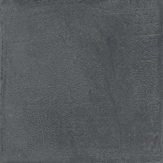 A tiled surface featuring Chalk 8x8 Dark Matte porcelain tiles, showcasing the overall pattern and slight variation.