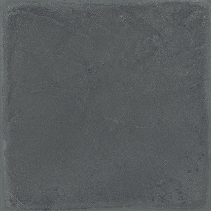 An example of Chalk 8x8 Dark Matte porcelain tiles installed in a modern interior setting, highlighting its concrete aesthetic.
