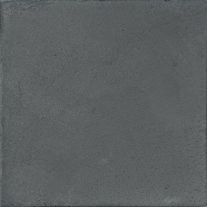 A stack of Chalk 8x8 Dark Matte porcelain tiles, demonstrating the consistent sizing and non-rectified edges.