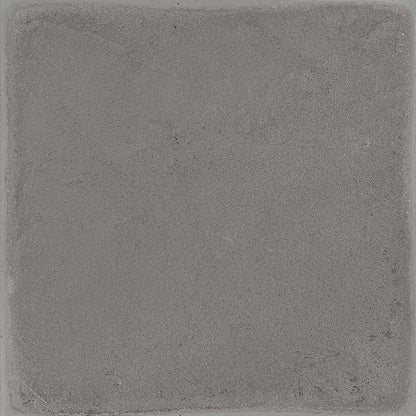 A stack of Chalk 8x8 Grey Matte porcelain tiles, showcasing the tile's thickness and non-rectified edge.
