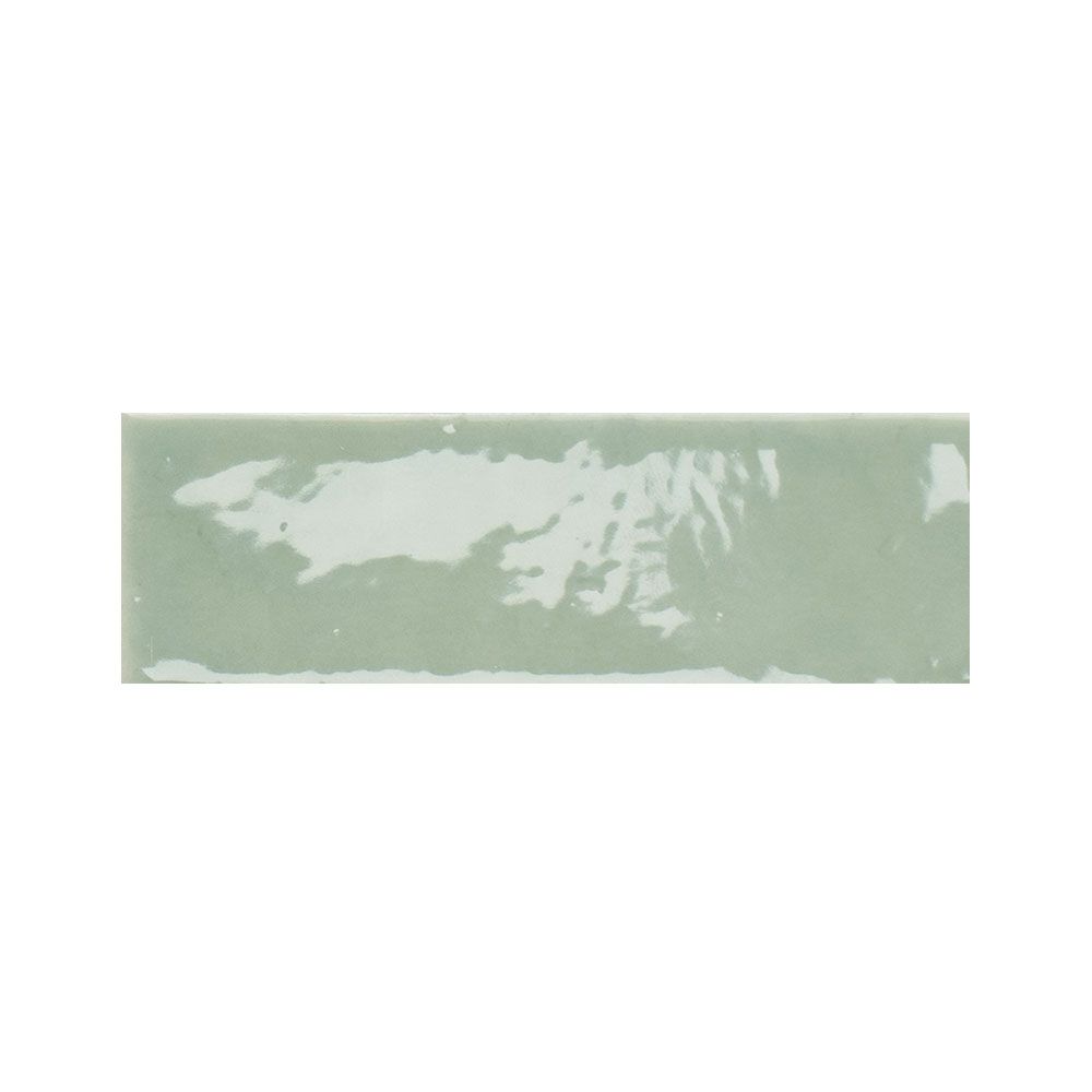 Room scene featuring 2x5 inch kiwi green gloss ceramic tiles installed on a wall