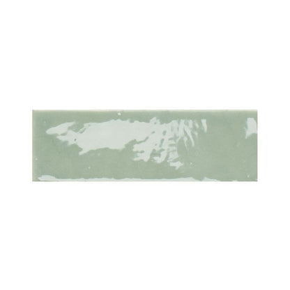 Room scene featuring 2x5 inch kiwi green gloss ceramic tiles installed on a wall