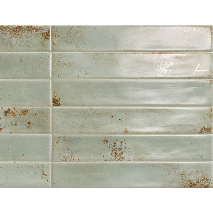 Arrangement of multiple Cool 2"x12" Emerald Satin ceramic wall tiles, highlighting the moderate variation in tone and pattern