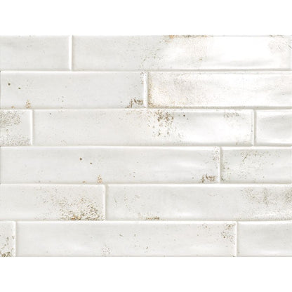 A stack of Cool 2"x12" White Satin Ceramic Wall Tiles, highlighting their consistent size and finish.