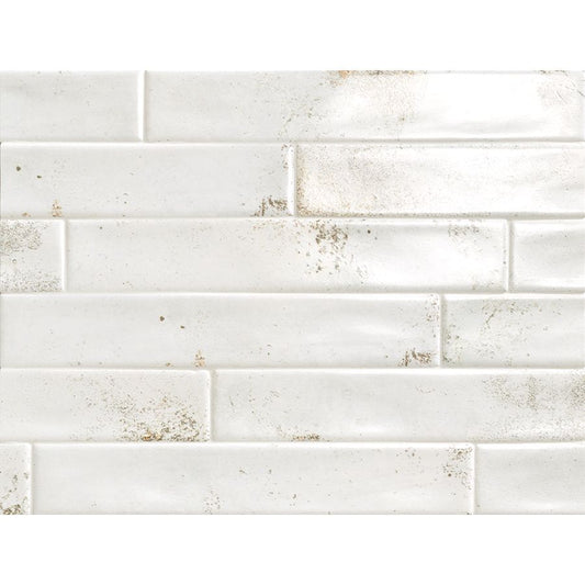 A stack of Cool 2"x12" White Satin Ceramic Wall Tiles, highlighting their consistent size and finish.