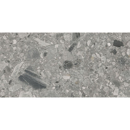 A sample of the Ceppo Grey Matte tile next to a tape measure to show its 12x24 size