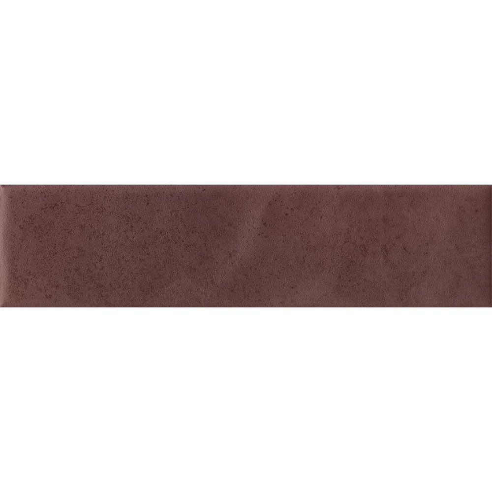Detail of the matte finish and color variation on a Cera 2x9 Amaranto Jam tile