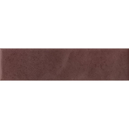 Detail of the matte finish and color variation on a Cera 2x9 Amaranto Jam tile