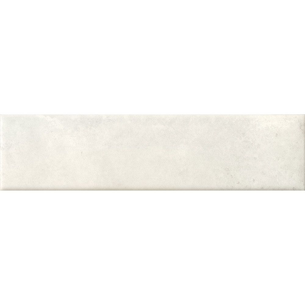 Detail of the edge and surface of a Cera 2"x9" Bianco Latte Matte Porcelain Wall Tile, emphasizing its matte finish.