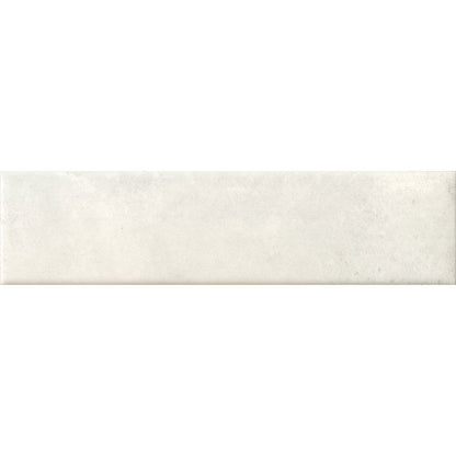 Detail of the edge and surface of a Cera 2"x9" Bianco Latte Matte Porcelain Wall Tile, emphasizing its matte finish.
