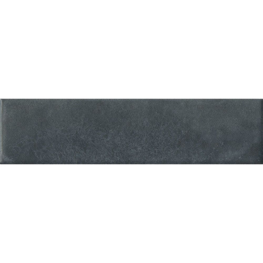 Stack of Cera 2x9 Blu Notte matte porcelain wall tiles showing the deep blue color