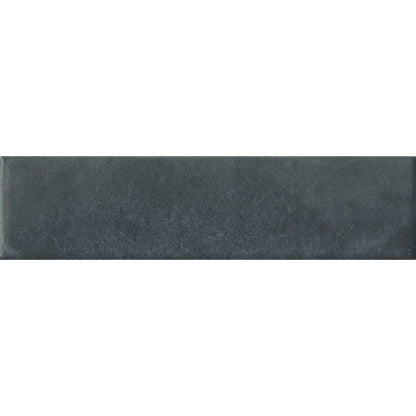Stack of Cera 2x9 Blu Notte matte porcelain wall tiles showing the deep blue color