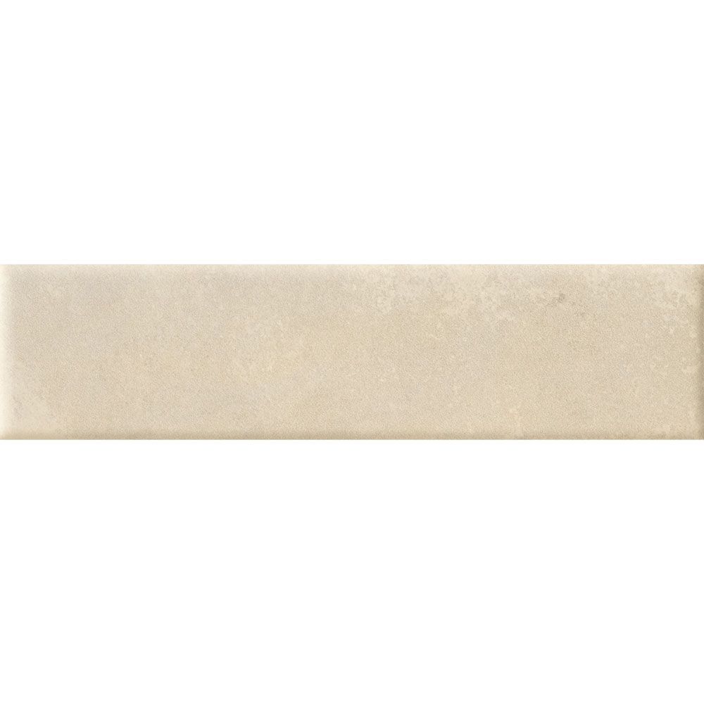 A stack of Cera 2"x9" Cashmere Melato Matte porcelain wall tiles, showing the uniform size and color consistency.
