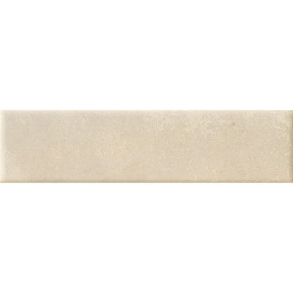 A stack of Cera 2"x9" Cashmere Melato Matte porcelain wall tiles, showing the uniform size and color consistency.