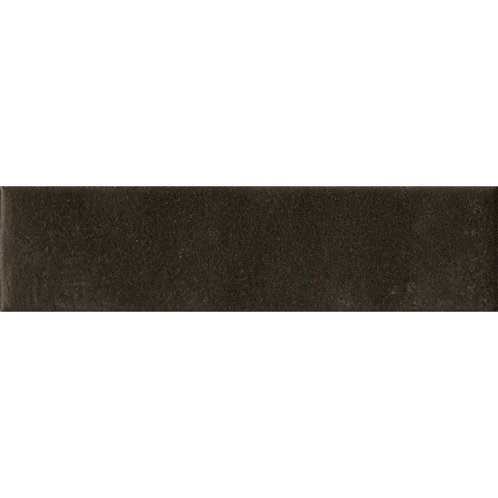 Stack of Cera 2x9 Nero Inchiostro matte porcelain wall tiles, showing the tile's thickness and edge