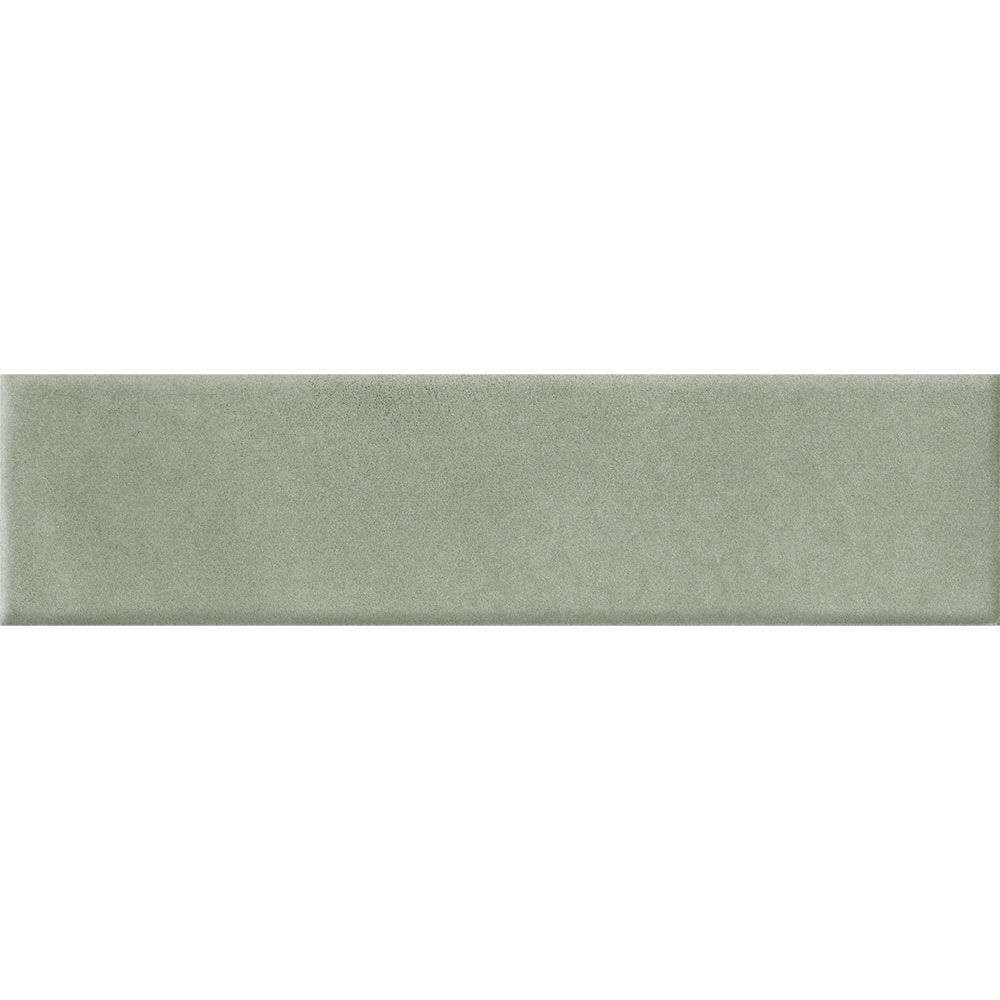 A stack of Cera 2x9 Verde Candito matte porcelain wall tiles, highlighting their uniform size and velvety satin surface.