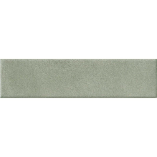 A stack of Cera 2x9 Verde Candito matte porcelain wall tiles, highlighting their uniform size and velvety satin surface.